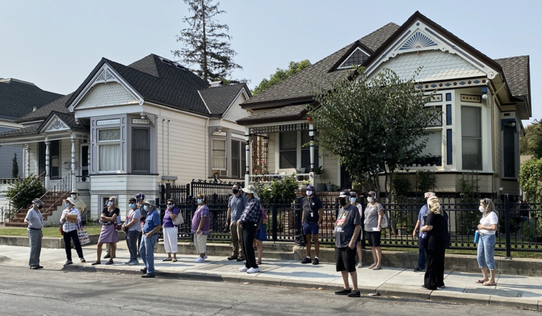 A group safely tours one of San Jose's historic neighborhoods using the audio headsets